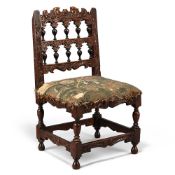 A DUTCH CARVED WALNUT AND EBONISED MINIATURE CHAIR, CIRCA 1680