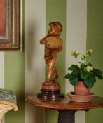 AN ITALIAN CARVED CYPRESS WOOD FIGURE OF A CHILD, 19TH CENTURY