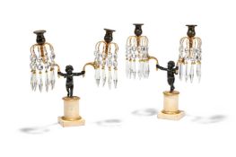 A PAIR OF REGENCY GILT AND PATINATED BRONZE AND WHITE MARBLE CHERUB CANDELABRA, EARLY 19TH CENTURY