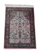 A FINE SILK TABRIZ RUG