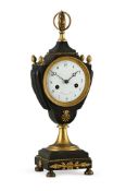 A FRENCH EMPIRE ORMOLU AND PATINATED BRASS URN MANTEL CLOCK