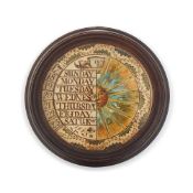AN UNUSUAL GEORGE III EBONISED FRAMED MANUAL REVOLVING WHEEL CALENDAR