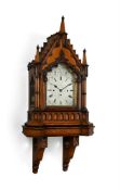 A VICTORIAN GOTHIC REVIVAL CARVED OAK QUARTER-CHIMING BRACKET CLOCK WITH ORIGINAL WALL BRACKET