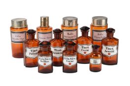 A SELECTION OF AMBER GLASS DRUG JARS AND COVERS, IN 19TH CENTURY STYLE