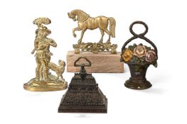 A GROUP OF FOUR DOOR STOPS OR DOOR PORTERS, VARIOUS DATES