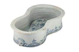 A FRENCH FAIENCE BLUE AND WHITE BIDET, IN 18TH CENTURY ROUEN STYLE, 19TH CENTURY