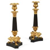 A PAIR OF PATINATED METAL AND GILT BRONZE CANDLESTICKS, LATE 19TH OR EARLY 20TH CENTURY