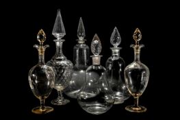 FOUR VARIOUS CLEAR GLASS CHEMIST JARS AND FACETED STOPPERS, TOGETHER WITH A PAIR OF DECANTERS