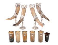 A SET OF FOUR SILVER PLATE DRINKING HORNS, TOGETHER WITH A SET OF SIX SIMILAR BEAKERS