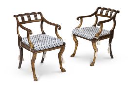 A PAIR OF EBONSED AND PARCEL GILT ARMCHAIRS, IN REGENCY STYLE, 20TH CENTURY