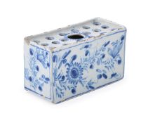 AN ENGLISH DELFT BLUE AND WHITE FLOWER-BRICK, MID 18TH CENTURY