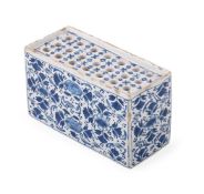 AN ENGLISH DELFT BLUE AND WHITE FLOWER-BRICK, MID 18TH CENTURY
