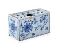 AN ENGLISH DELFT BLUE AND WHITE FLOWER-BRICK, MID 18TH CENTURY