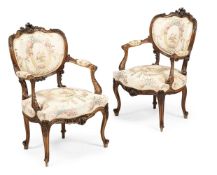 A PAIR OF CARVED WALNUT AND UPHOLSTERED ARMCHAIRS WITH SHIELD SHAPED BACKS, FRENCH, MID 19TH CENTURY