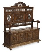 A LARGE CARVED OAK BOX SETTLE, PROBABLY CONTINENTAL, CIRCA 1885