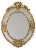 AN OVAL CARVED WOOD AND GILT GESSO WALL MIRROR, IN THE LOUIS XIV STYLE, FRENCH
