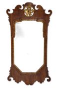 A GEORGE II WALNUT AND PARCEL GILT FRET-CARVED MIRROR, CIRCA 1740