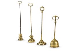 FOUR LARGE BRASS DOOR PORTERS OR DOOR STOPS, LATE 19TH/EARLY 20TH CENTURY