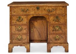 A GEORGE II WALNUT KNEEHOLE DESK OR DRESSING-TABLE, CIRCA 1720