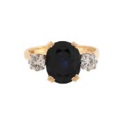 A DIAMOND AND SAPPHIRE THREE STONE RING
