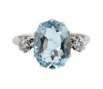 AN AQUAMARINE AND DIAMOND THREE STONE RING