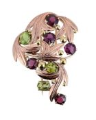 A PERIDOT AND GARNET SPRAY BROOCH
