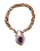 AN EARLY VICTORIAN GARNET SET HEART SHAPED LOCKET ON BRACELET
