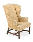 A GEORGE III UPHOLSTERED AND MAHOGANY WING ARMCHAIR, CIRCA 1785