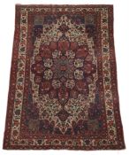 A RED GROUND HERIZ RUG, 20TH CENTURY
