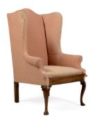 A GEORGE II ELM AND UPHOLSTERED WING BACK ARMCHAIR, CIRCA 1750