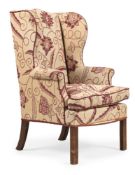 A GEORGE III UPHOLSTERED AND MAHOGANY WING BACK ARMCHAIR, CIRCA 1780