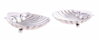 A PAIR OF VICTORIAN SILVER SHELL SHAPED BUTTER DISHES