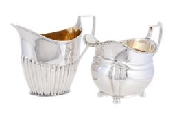 A SILVER OBLONG BALUSTER MILK JUG