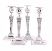 A SET OF FOUR VICTORIAN SILVER CANDLESTICKS