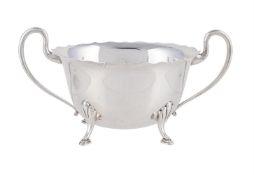 A SILVER SHAPED OVAL TWIN HANDLE SUGAR BOWL