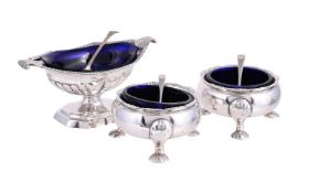 A GEORGE III SILVER PEDESTAL SALT AND A PAIR OF GEORGE II CAULDRON SALTS