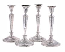 A SET OF FOUR GEORGE III SILVER CANDLESTICKS