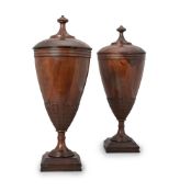 Y A PAIR OF MAHOGANY COVERED URNS OF GEORGE III STYLE
