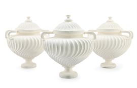 A SET OF THREE TWO HANDLED PLASTER 'PIRANESI' URNS, BY SOANE
