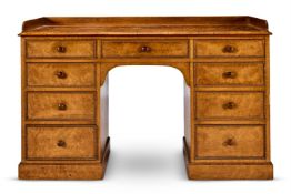 AN EARLY VICTORIAN BIRDS EYE MAPLE KNEEHOLE DRESSING-TABLE, CIRCA 1840