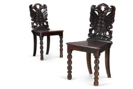 A PAIR OF VICTORIAN CARVED OAK HALL CHAIRS, MID-19TH CENTURY