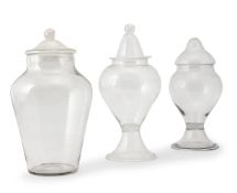 THREE VARIOUS CLEAR-GLASS STORAGE JARS AND COVERS, LATE 19TH CENTURY OR LATER