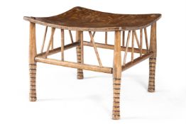 A 'THEBES' STOOL IN THE MANNER OF E.W.GODWIN, LATE 19TH/EARLY 20TH CENTURY