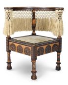 A CORNER CHAIR WITH BRASS AND PEWTER INLAY, CARVED AND REPOUSSÉ DECORATION BY CARLO BUGATTI
