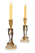 A PAIR OF NEOCLASSICAL GILT AND PATINATED BRONZE CANDLESTICKS, POSSIBLY ITALIAN