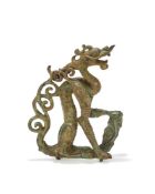 A rare bronze figure of a crouching dragon