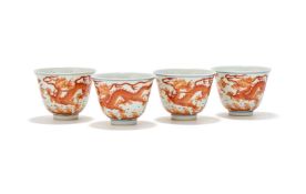 A set of four Chinese iron-red 'Dragon' wine cups