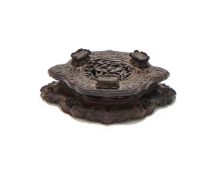 A Chinese carved hardwood quatrefoil stand