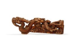 A Chinese gilt and lacquered wood carving of a dragon