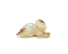 A Chinese pale celadon and russet jade carving of mythical beast